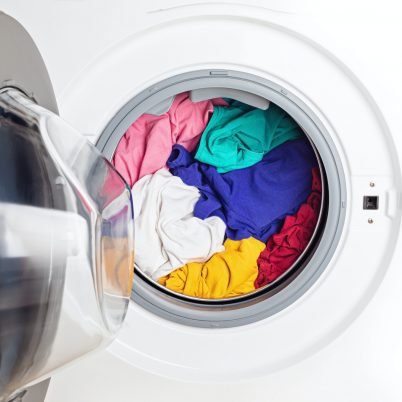 Washing or drying machine loaded with the laundry. Washing, spring cleaning idea